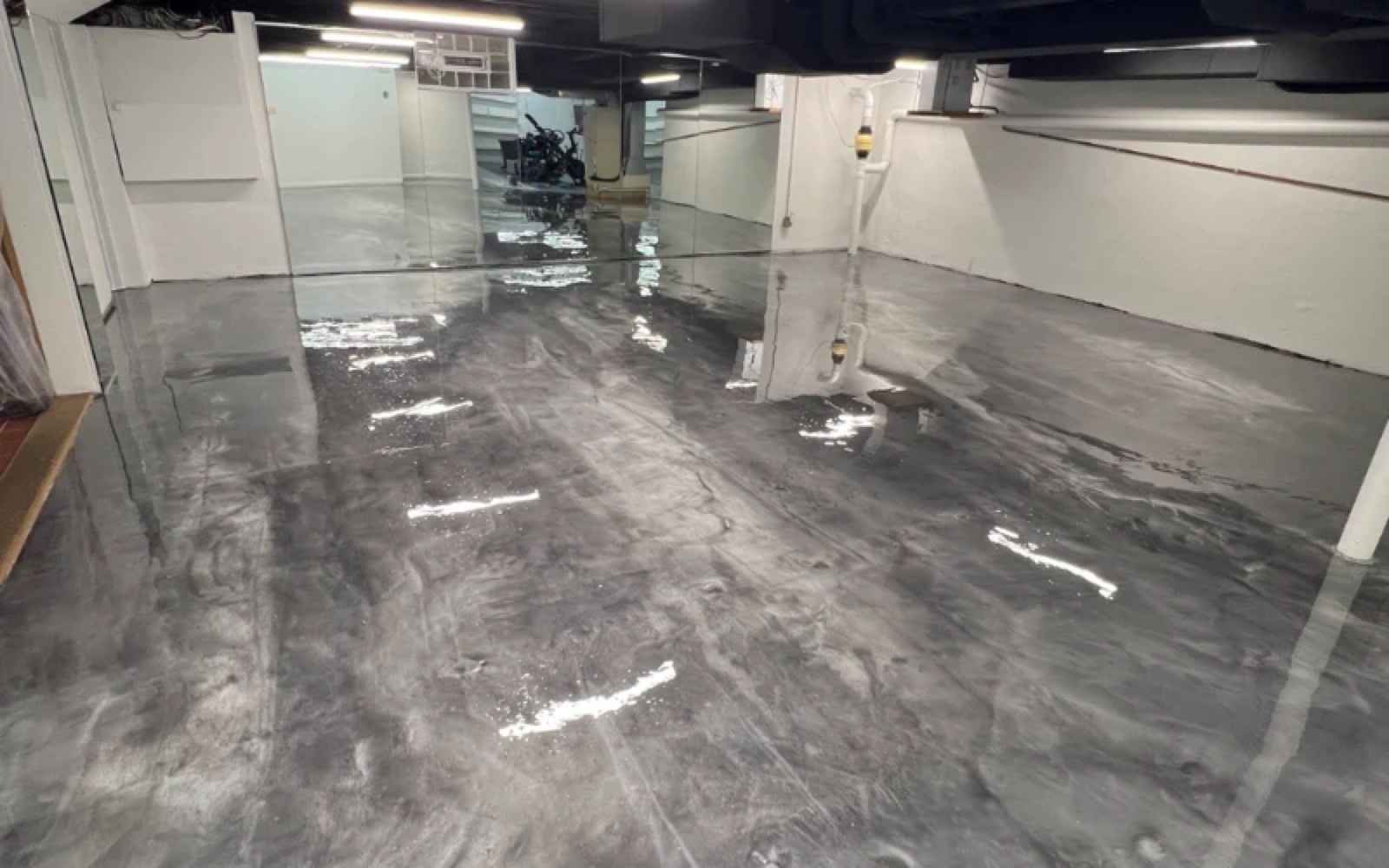 Basement with glossy gray and silver metallic epoxy flooring