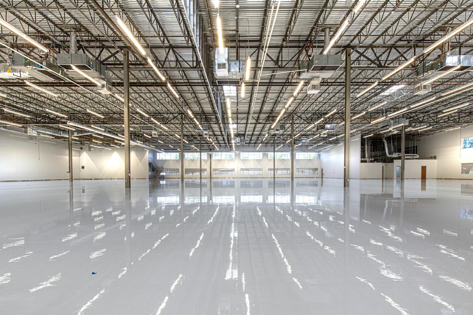 Industrial facility with reflective solid-gray epoxy flooring
