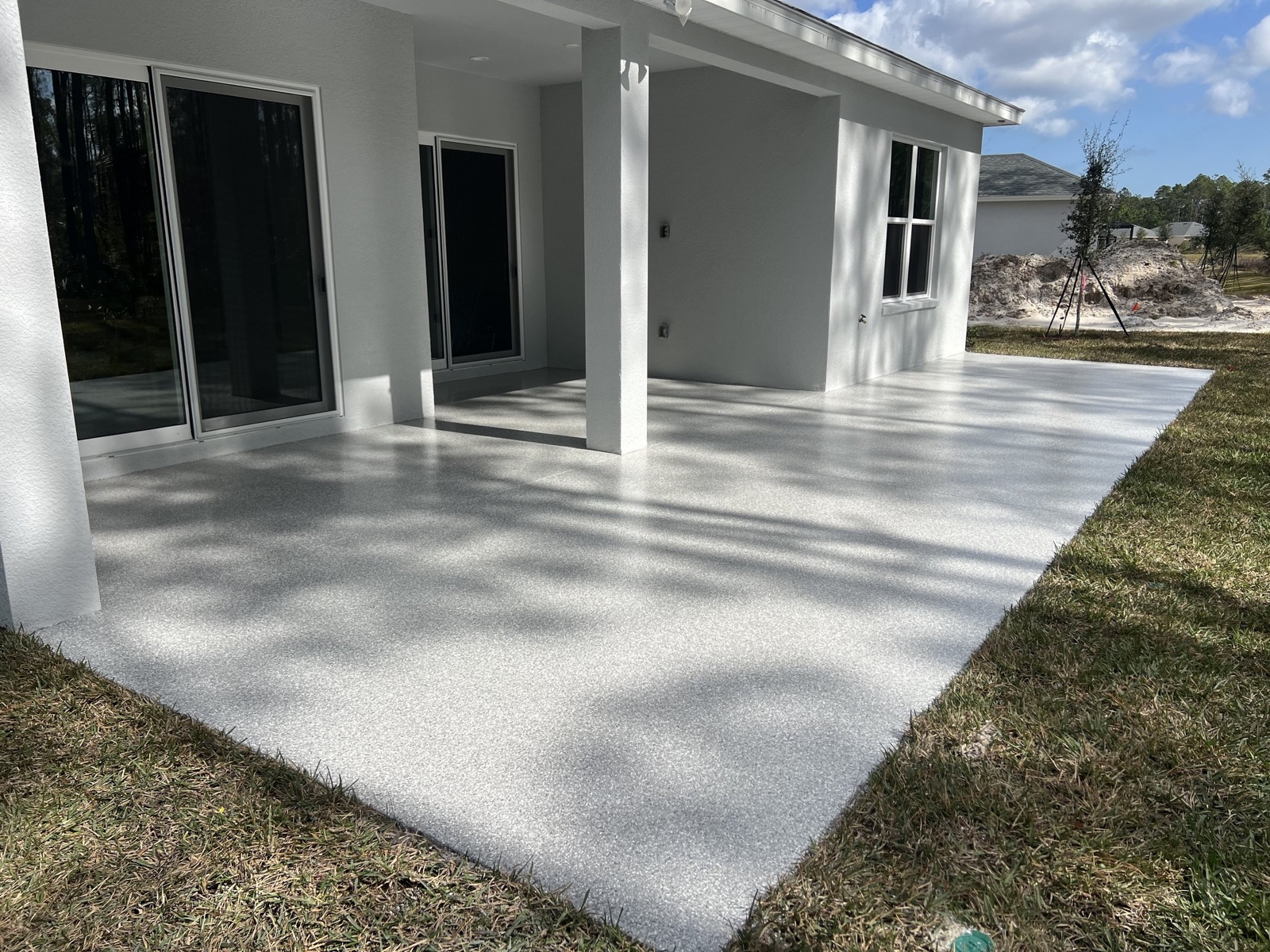 Covered patio with a light gray decorative flake coating