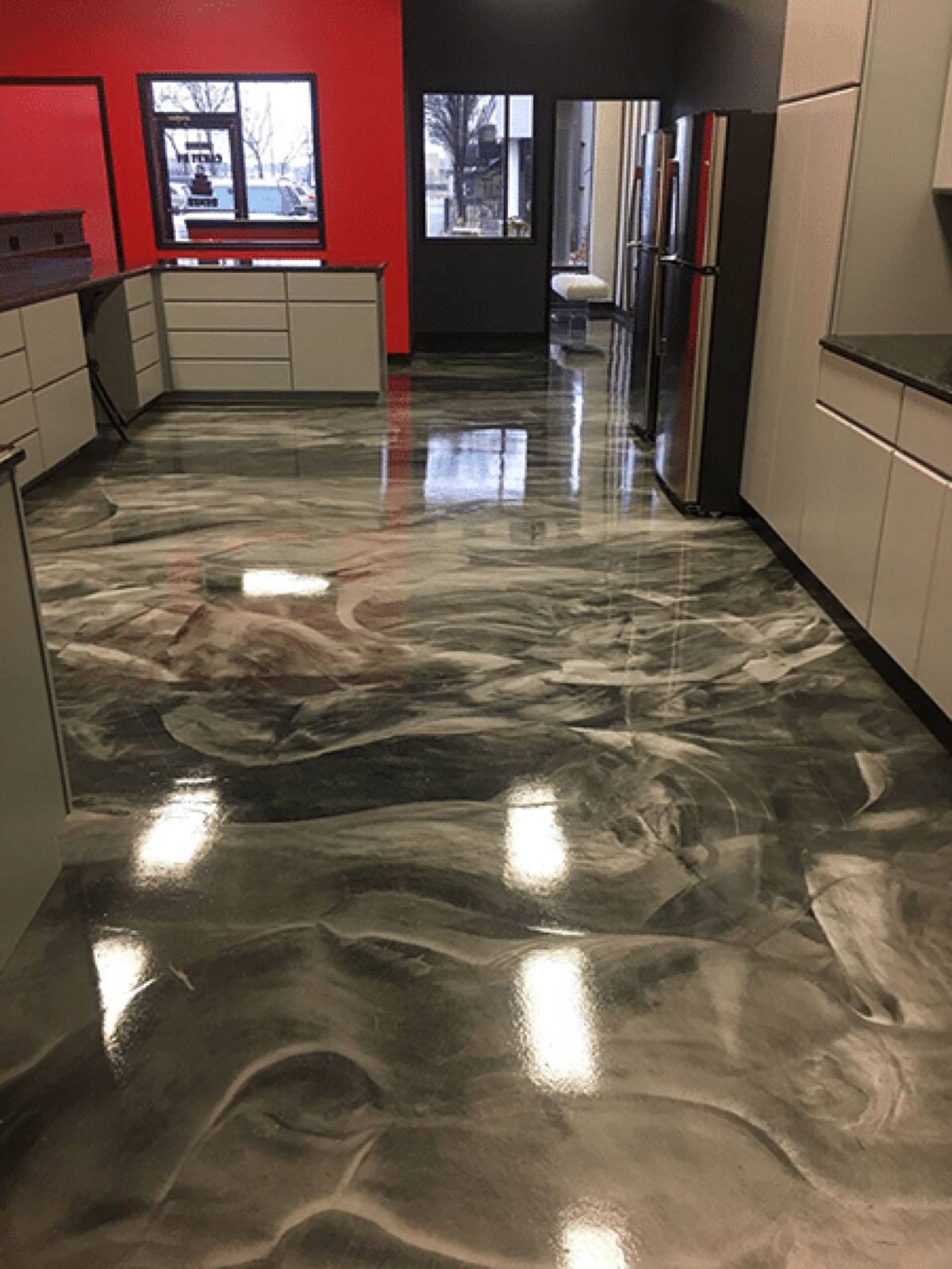 Appliance showroom with silver and charcoal metallic epoxy flooring