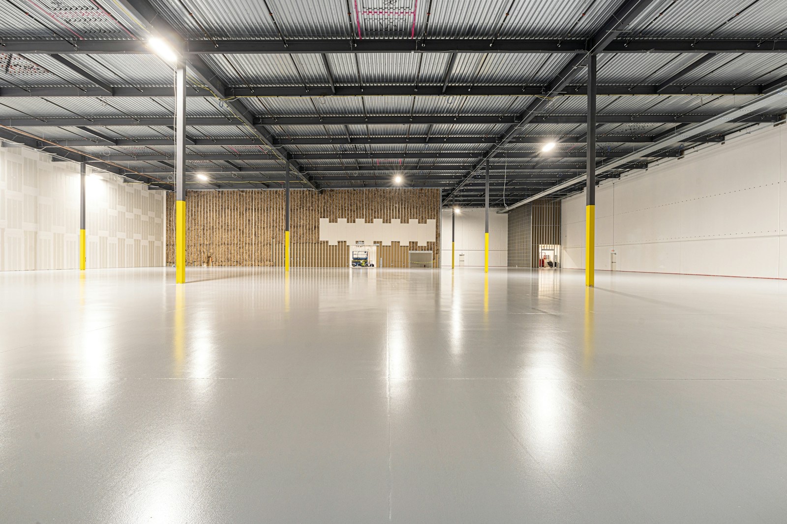 Open warehouse with seamless light-gray epoxy flooring